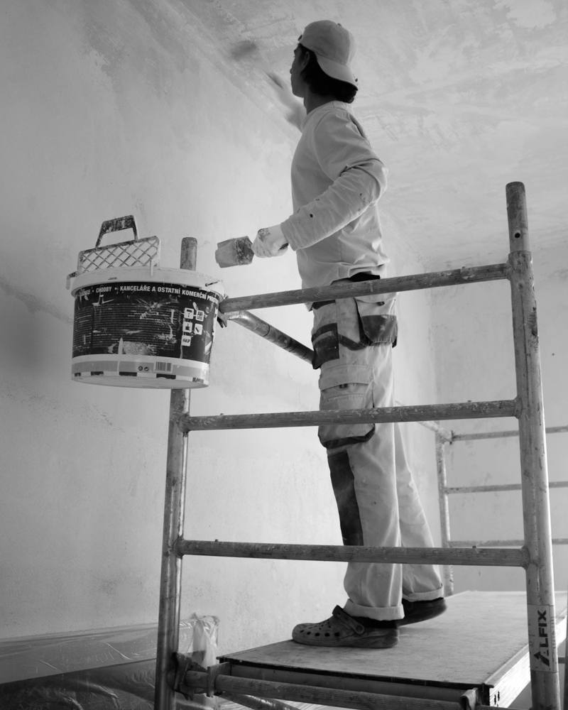 Painter rolling a fresh coat on an interior wall